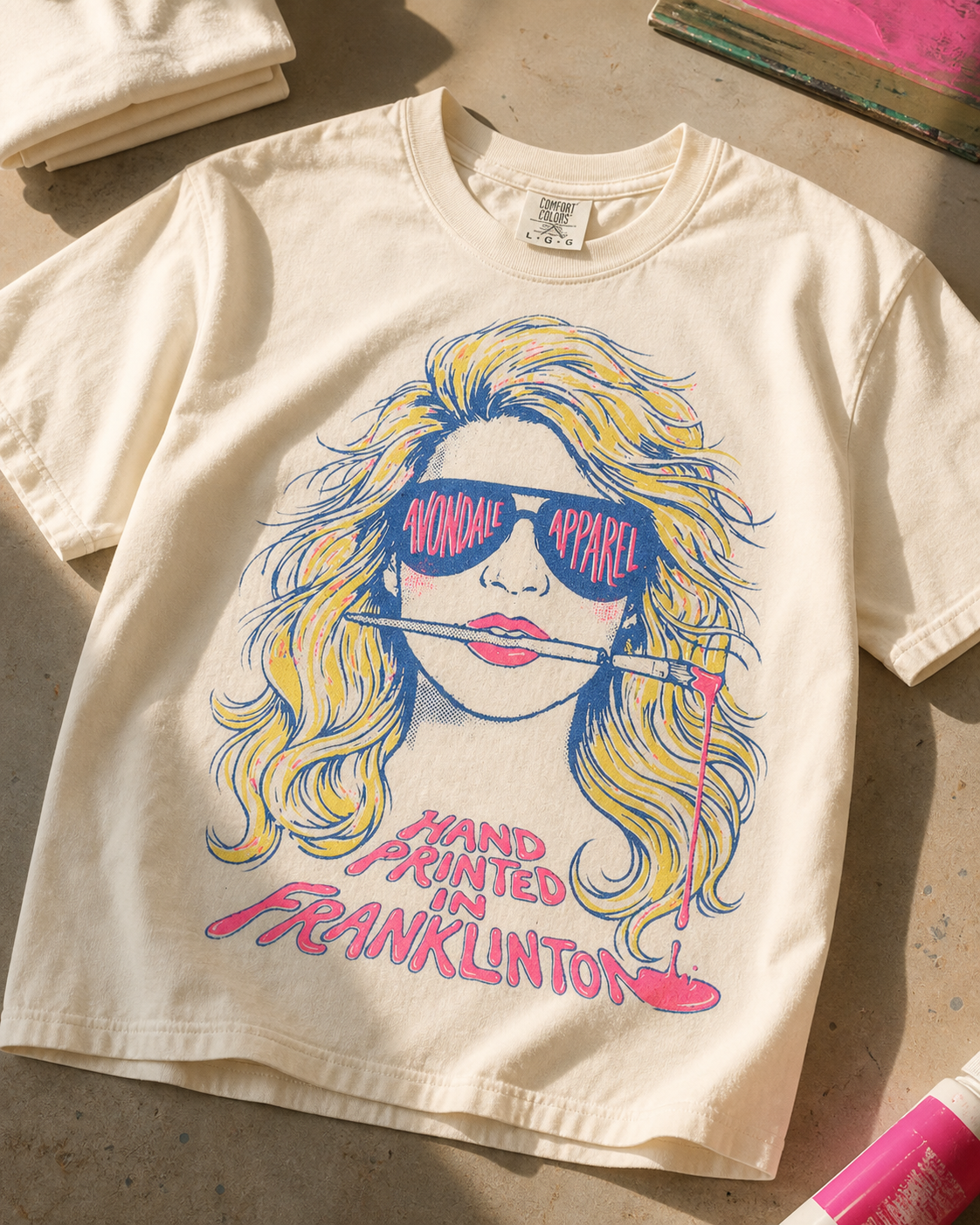 The Painter ivory tee studio flat lay with screen printing tools