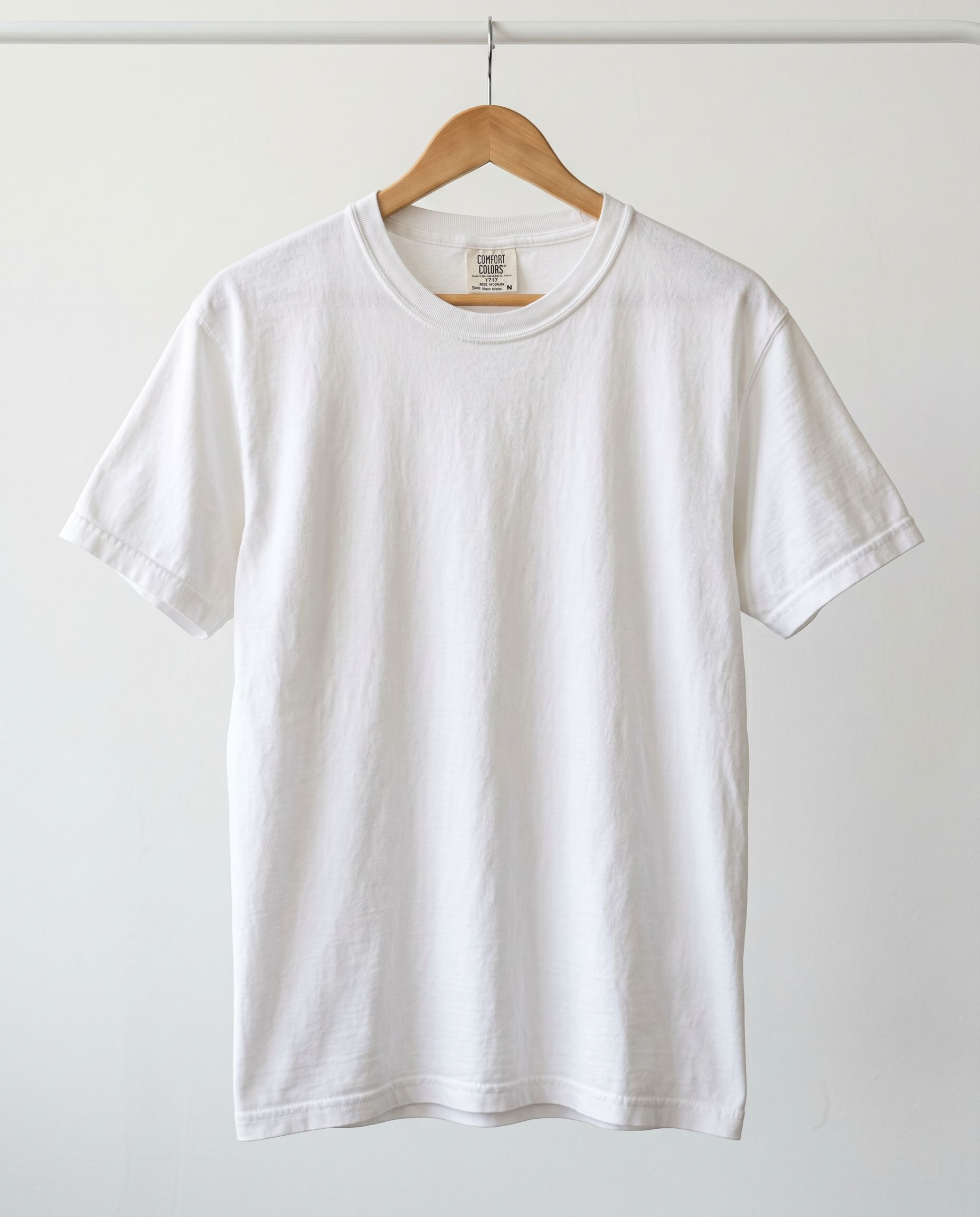 White T-shirt on a wooden hanger